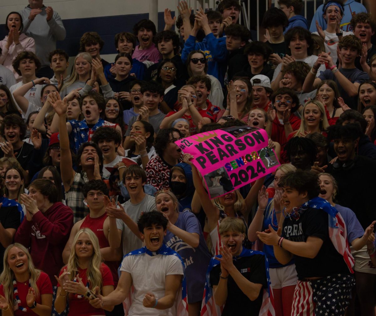 The student section shows out in their USA gear supporting the varsity boys basketball team during their senior night game on March 13.