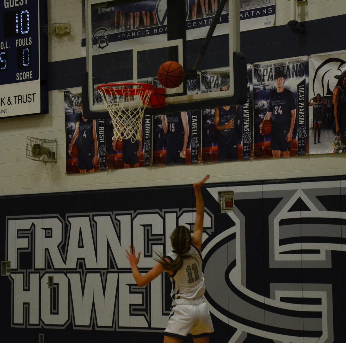 Junior Riley Henderson jumps upwards towards the basket, making a layup on Feb. 14.