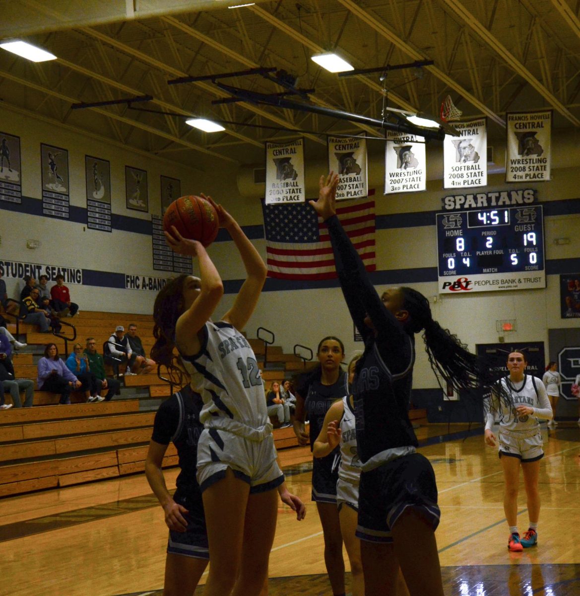 Junior Morgan Davis thrusts her arms up, hoping to get the ball over her defenders hands.