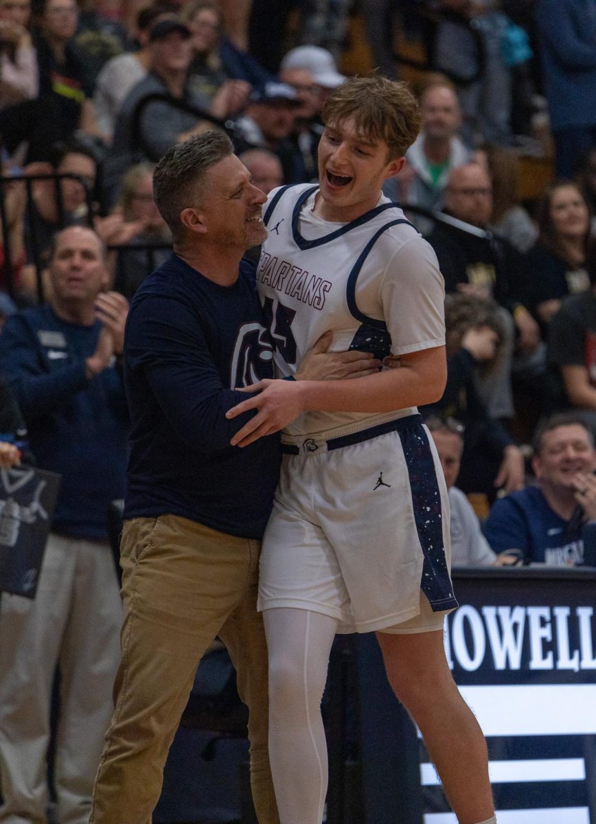 Senior Will Zadell leaves the court for the final time and gives Coach Brian Cissell a joyous hug.