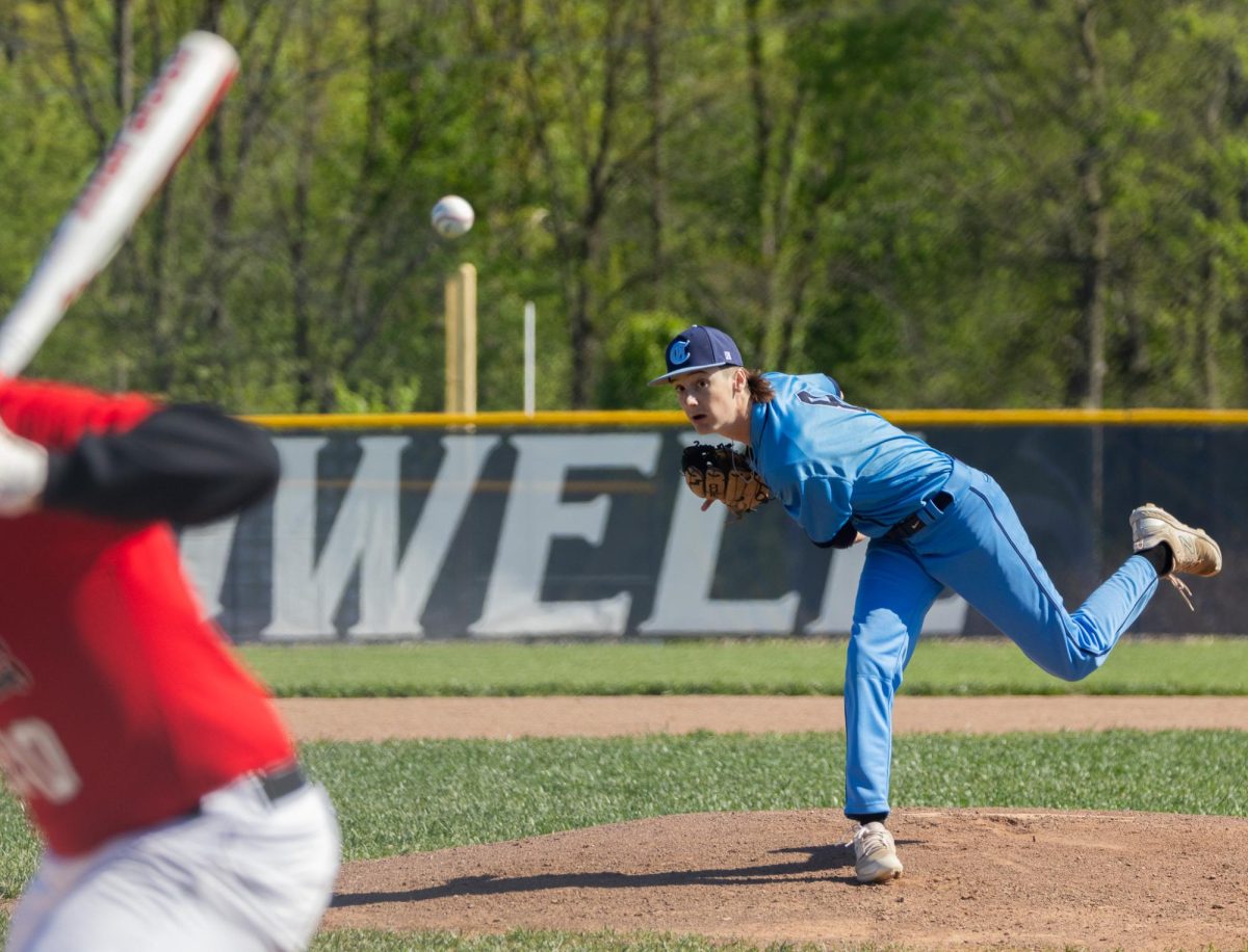 During the first inning of the game junior Sam Mueller pitches a curveball, striking out the batter from Parkway Central. Mueller pitched until the end of the fifth inning in the first of the two games. 