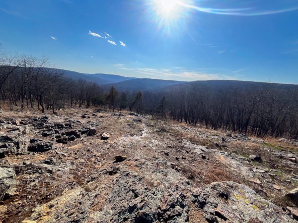 A mountainous view off the side of the Taum Sauk Mountain, with the trees and atmosphere displaying its beauty in the background. Photo taken by junior Jack Champion, edited by Summer Suarez.