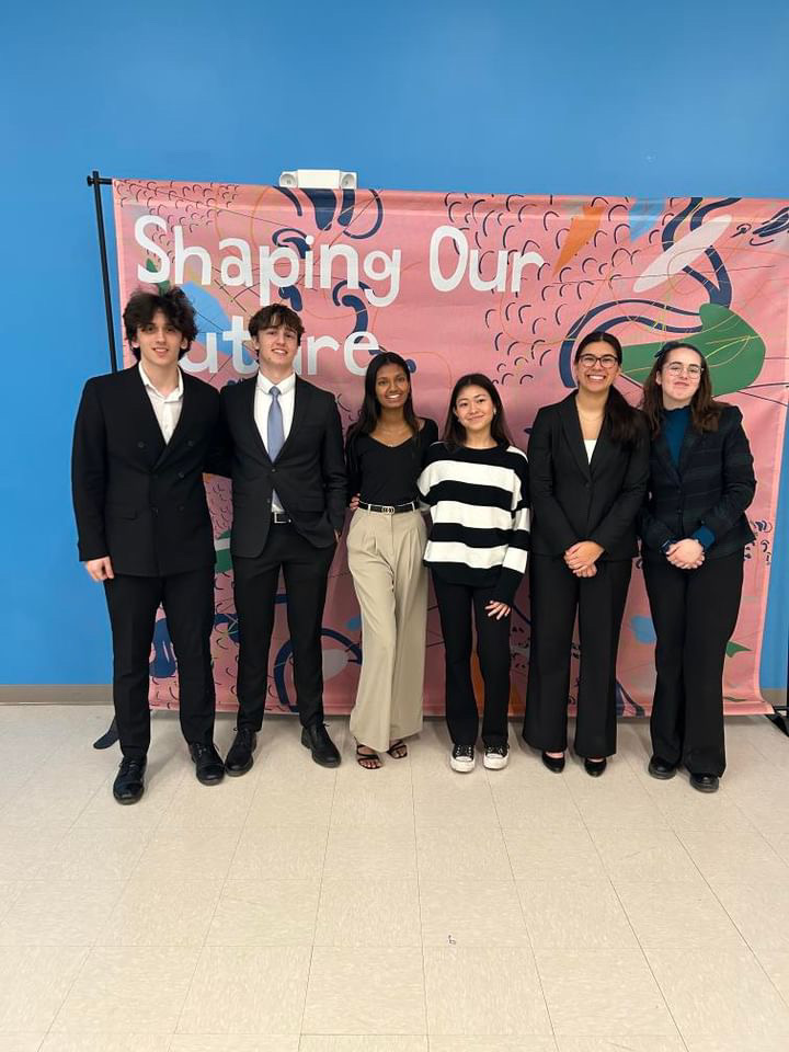 Marko Vhrovac, Luke Paulus, Natalee Shipley, and Addie Law stand during a Speech and Debate tournament. The photo was taken after Natalee and Addie placed second in public forum debate. Photo courtesy of Addie Law