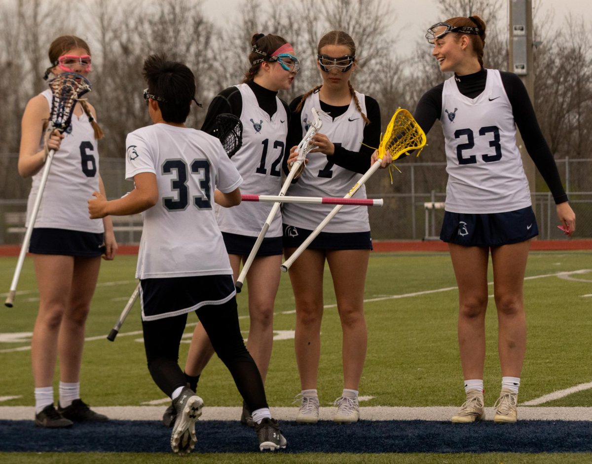 Junior+Varsity+Lacrosse+players+communicate+with+their+team+during+the+game.+Senior+Sophie+Shore+found+the+community+to+be+very+present+in+lacrosse.