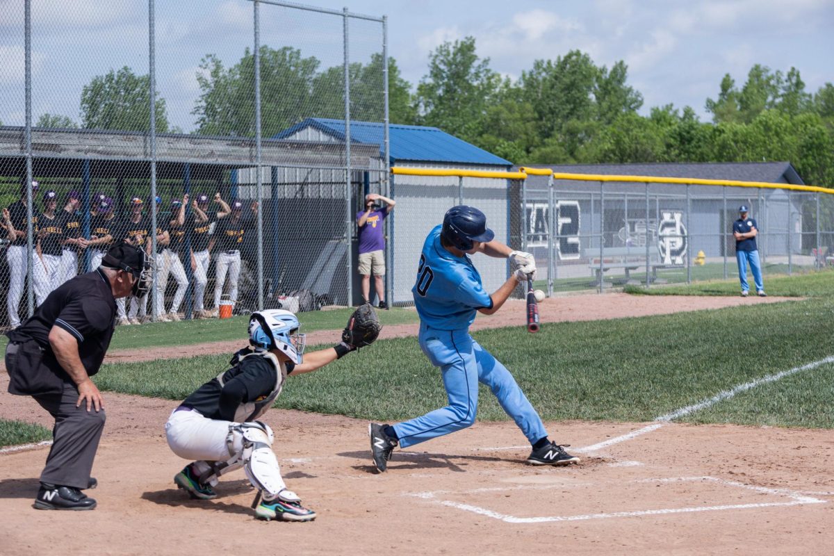 Senior Nate Rush swings at the ball allowing him to run to first base at the varsity vs Eureka game on May 4.
