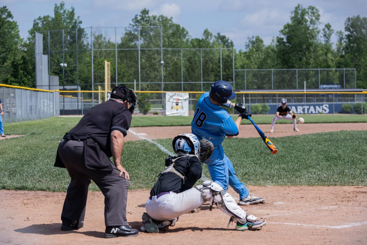 Senior Gabe Duncan swings at the ball hitting a homerun which allows him to run all of the bases. 
