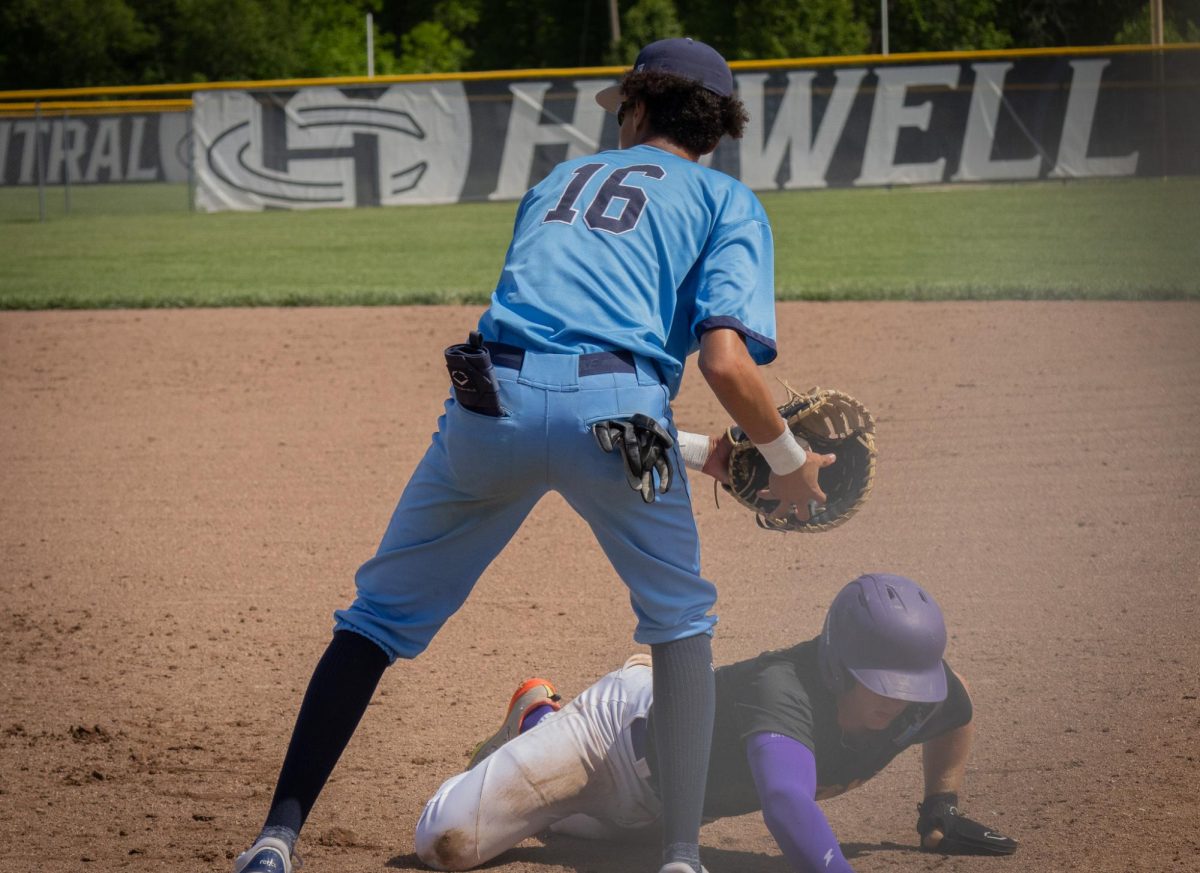 As a player from the opposing team attempts to steal second base, Junior Ethan Leflore catches a ball thrown from the pitcher in an effort to get the player out at the Central vs Eureka game on May 4. 