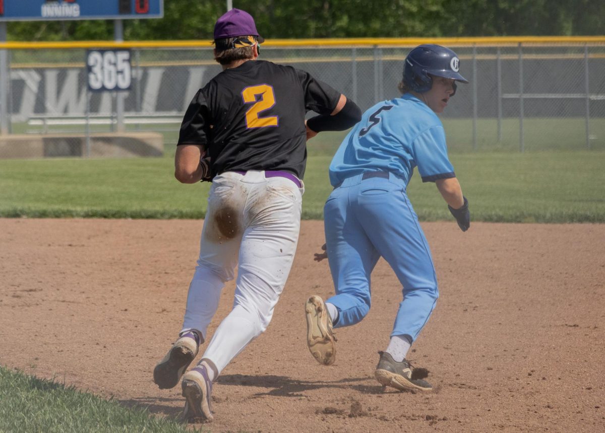 At the Central vs Eureka game on May 4, Freshman Carter Radeke runs from a member of the eureka team attempting to tag him and get him out. 