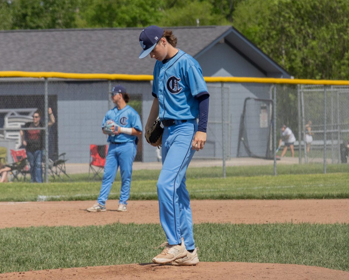 Before completing a pitch to a member of the Eureka team at the Central vs Eureka game, junior Sam Mueller looks down in order to visualize the pitch on May 4.