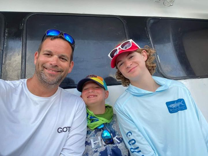 Senior Jack Rice sits with his dad and brother while on vacation. Photo courtesy of Jack Rice.