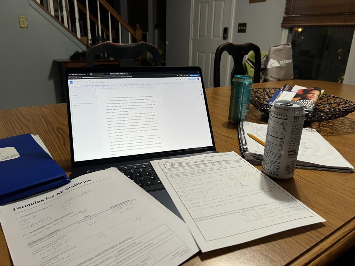 A couple of energy drinks are spread across the table dominated by a sprawl of folders, notebooks, and worksheets. This scene is not shocking as many students have caffeine addictions.