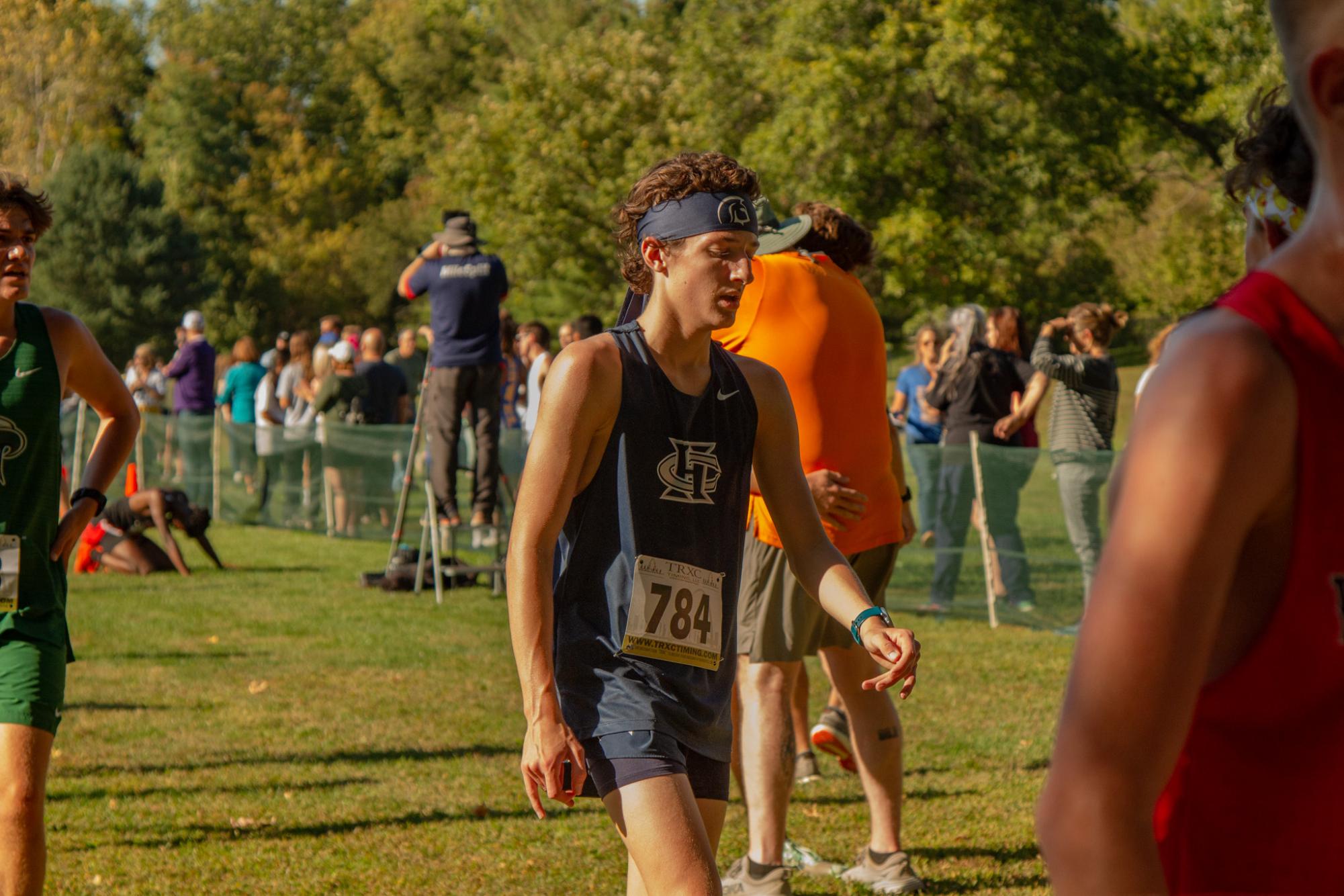 Freshman Dax Perry walks toward the team's tent after his GAC race. Perry's training in the heat through the summer and beginning of the season prepared him for racing on a hot day. 