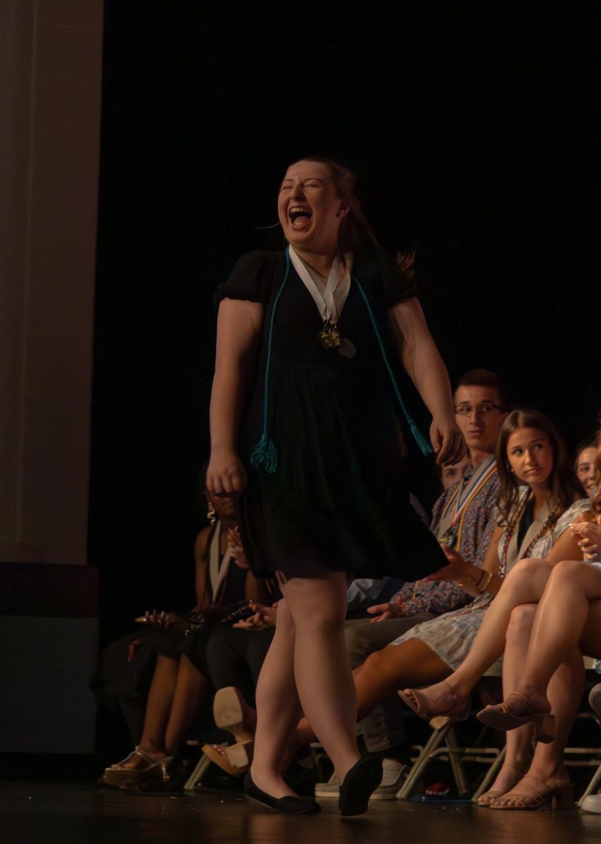 Senior Haley Ehle smiles as she walks across the stage to receive the departmental award for the dramatic arts. 