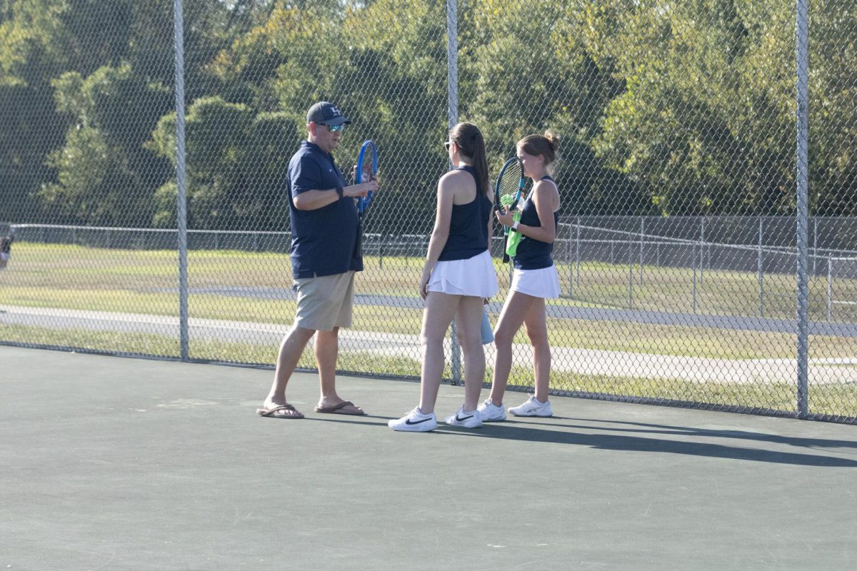 Coach Patrick Reed discusses better techniques and strategies to senior Rylie Schaefermeier and junior Lauren Wortkoetter