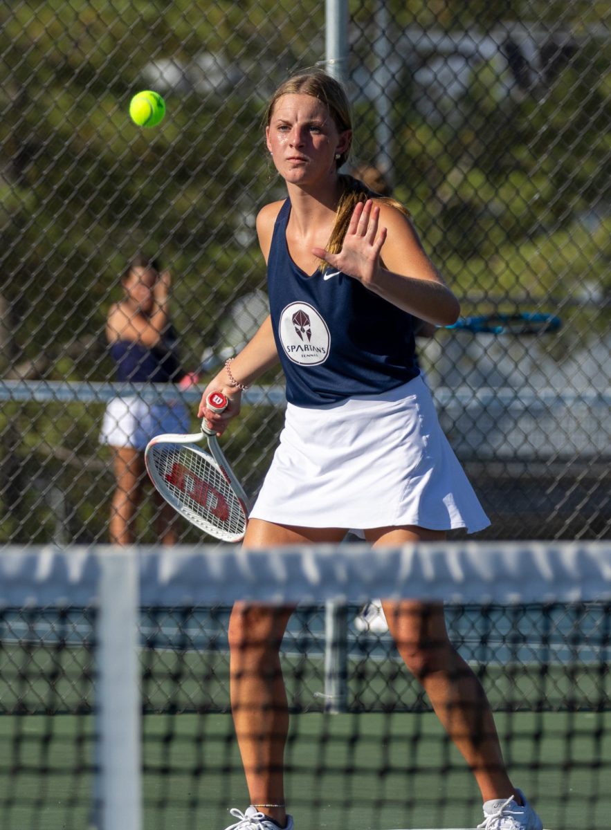 As the ball approaches her, junior Sam Taylor gets ready to volley it back across the net to her opponents from Helias. Taylor hit the ball strongly, sending it quickly to her opponents from Helias. 