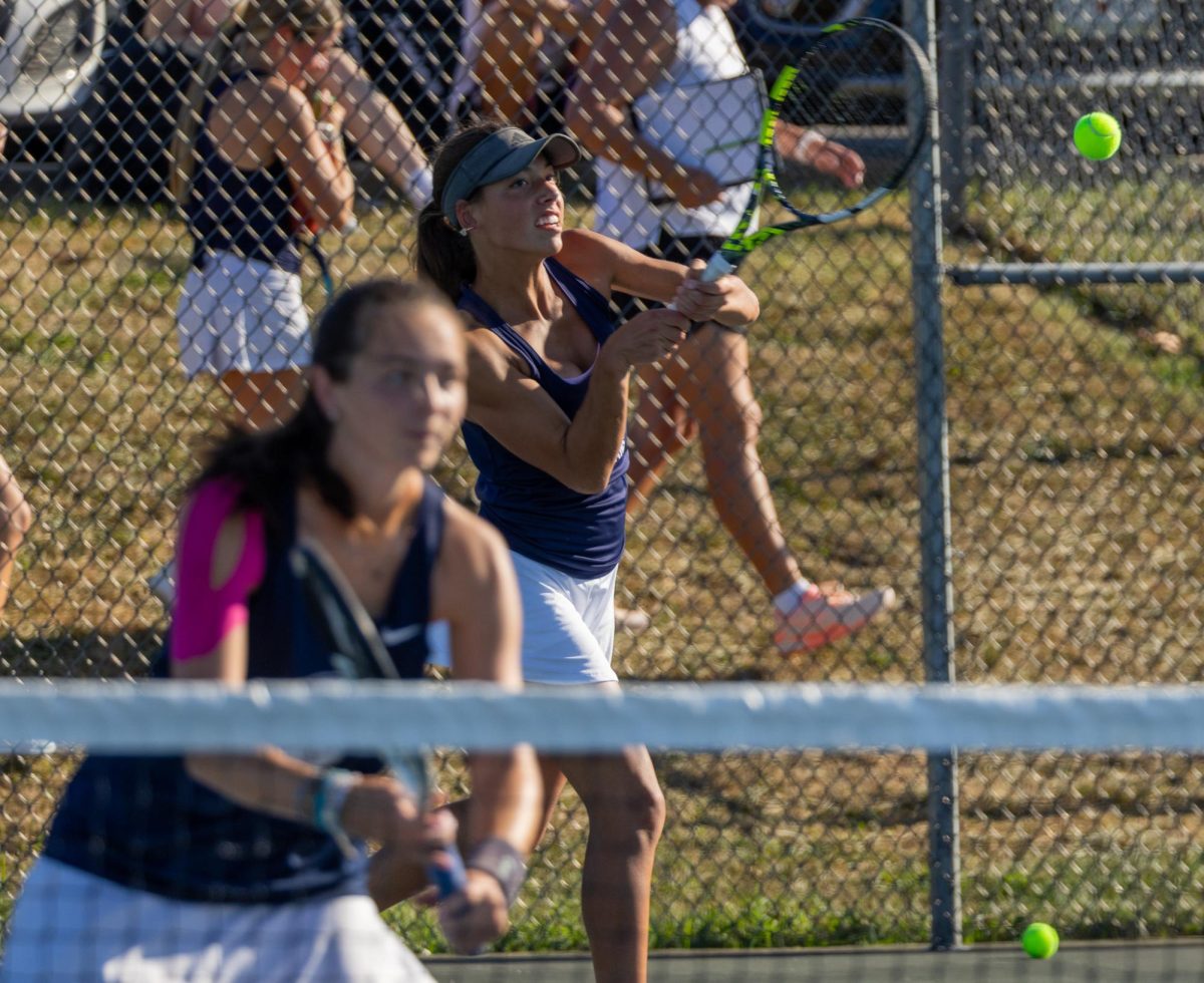 Ending the set, freshman Ashley Hayes smashes the ball and sends it flying over the net, landing in between the two players from Helias. This was during Hayes’ first double match of the day. 