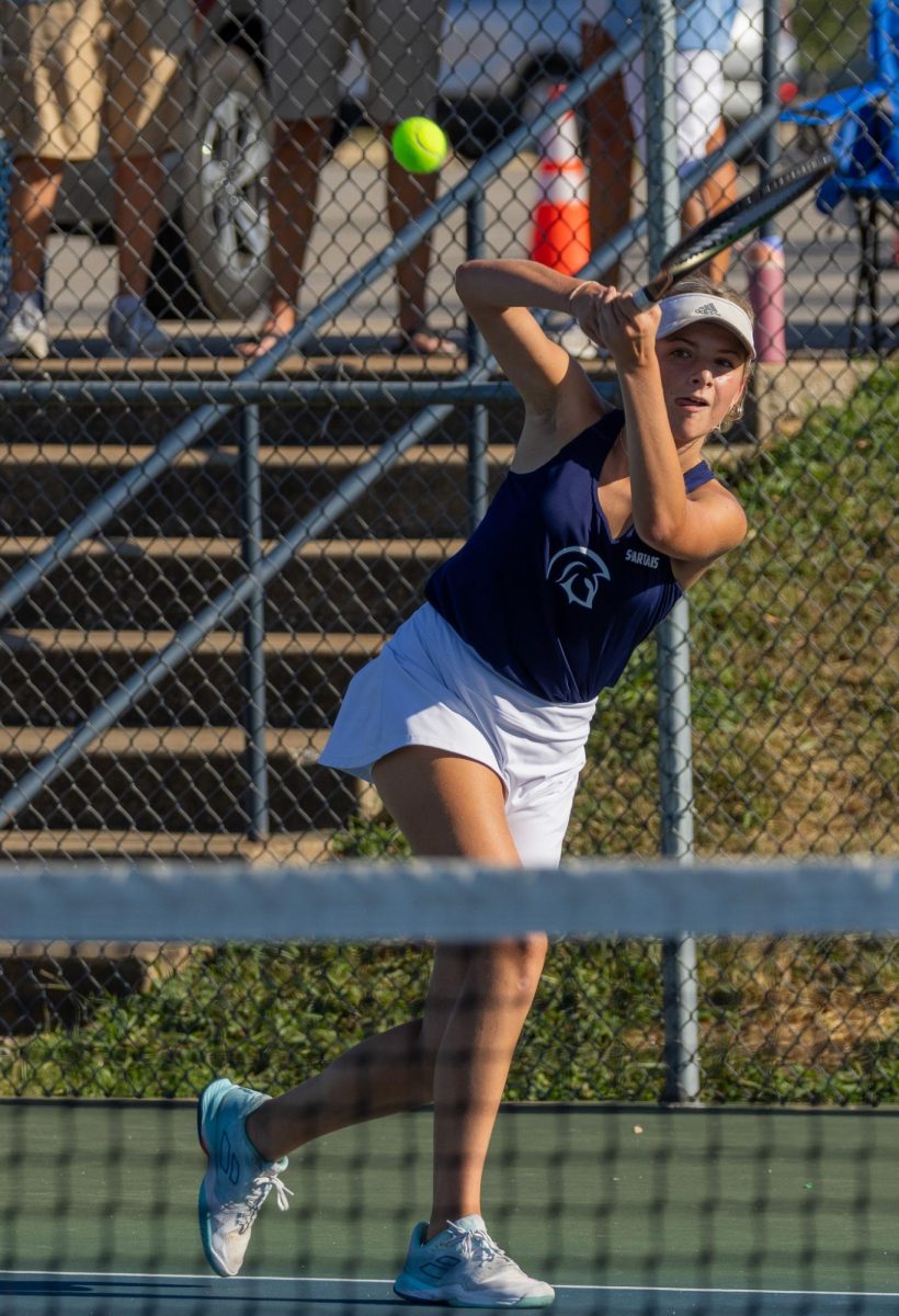 Isabel Black angles her body following through her swing, hitting a drop shot back over the net. A drop shot is one that lands close to the net on the other team’s, making it hard for the players to reach it in time.  