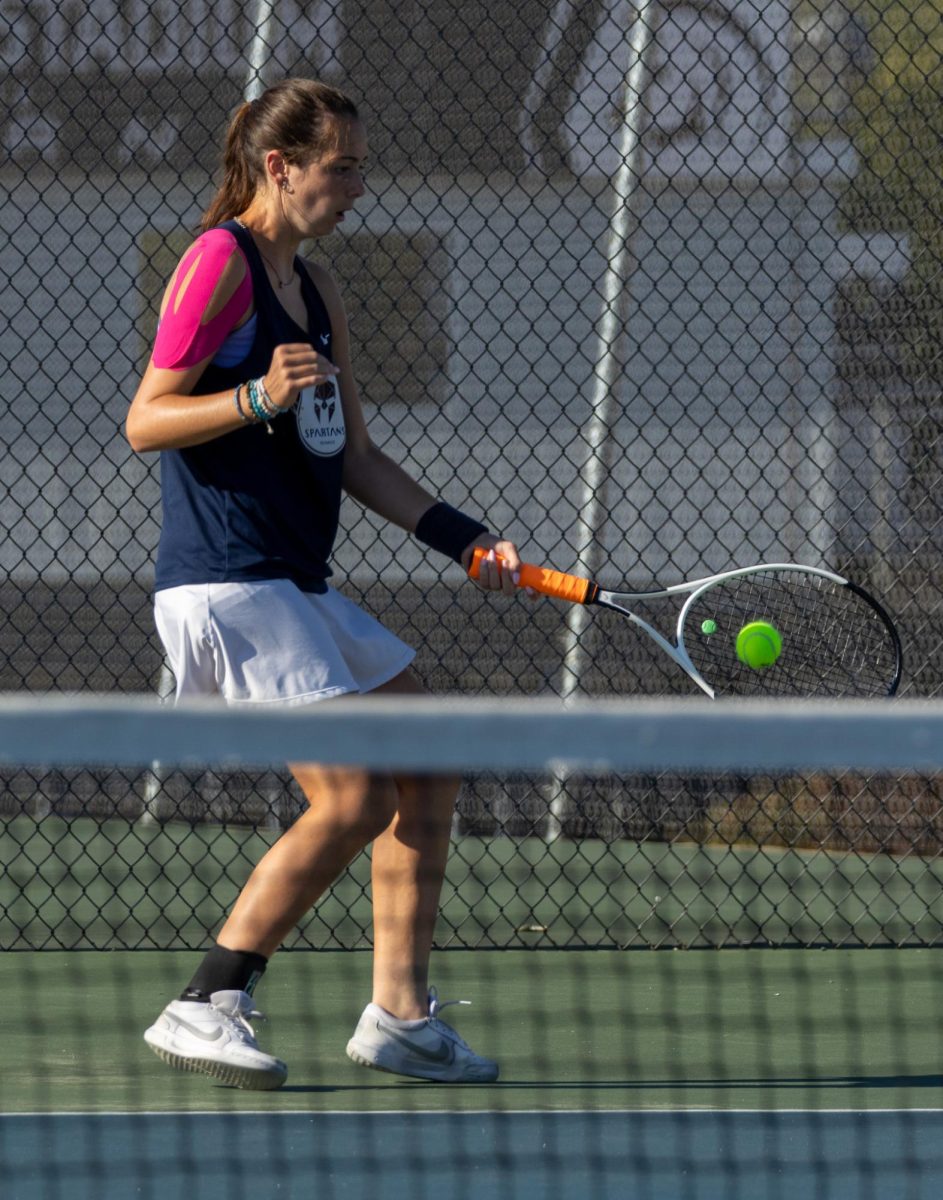 Molly Kate Morris swings her racquet forward to hit a ball. This type of stroke is called a forehand hit. 