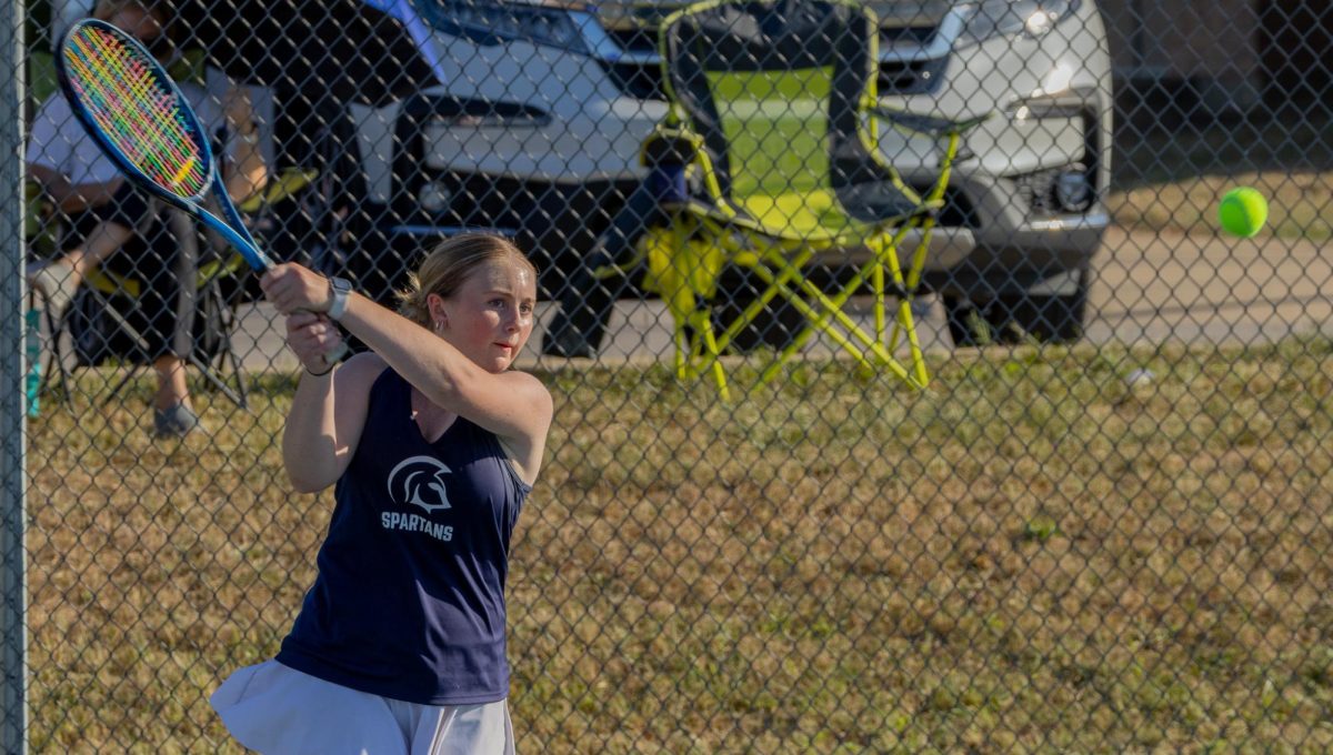 Pivoting her body sideways, sophomore Chloe Horton swings her racquet and sends the ball flying over the net. The ball landed in the corner of Helias’ side of the court, winning the point for. 