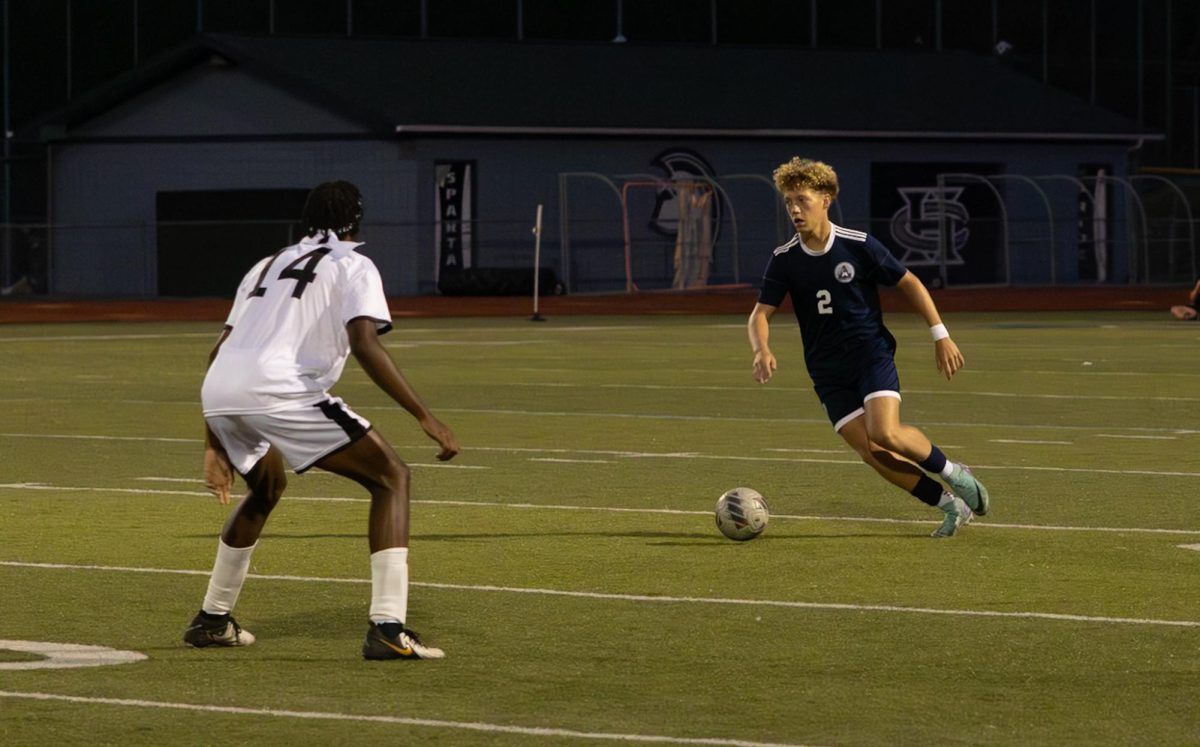 Sophomore Carter Radeke looks to the right of the defender to see his teammate who is open for a pass on Sept. 10 game against Francis Howell North. This pass will hopefully lead to the ball moving farther down the field. 
