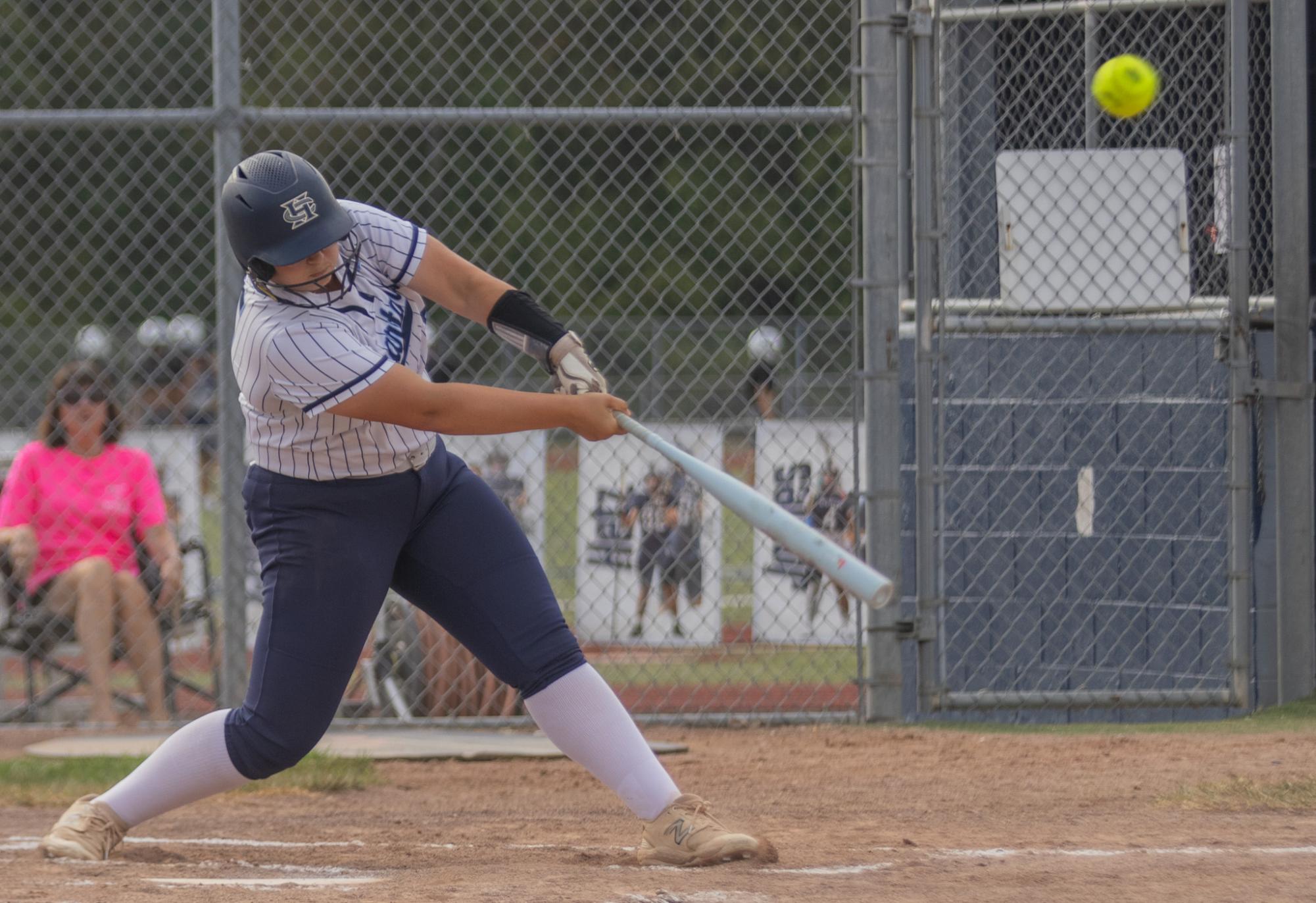 Junior Amelia Raziq hits the ball down the right baseline. Getting a double, she celebrated as she hit the team's double celebration. 