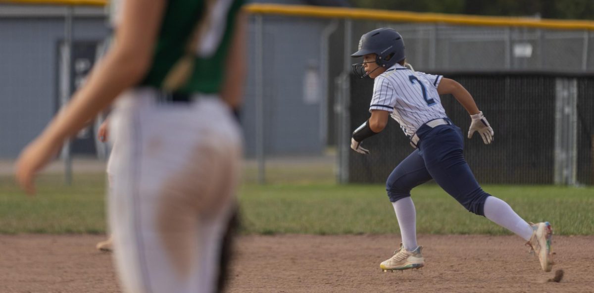 Running to third base, Sophomore Taylei Sesson looks at home to see if she is able to possibly score. She filled in as a runner for one of the players as she is able to get around the bases quickly. 