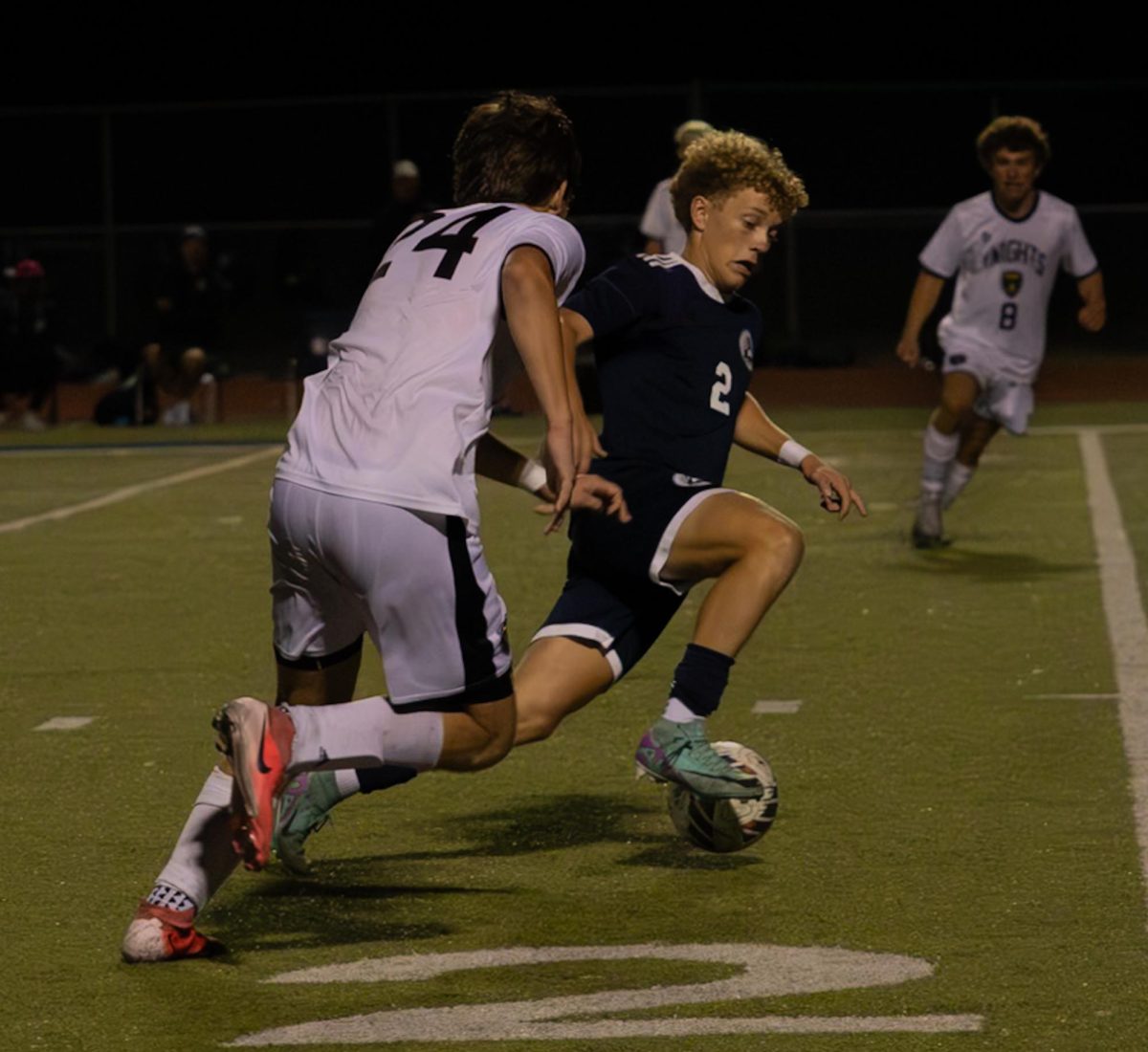 At the game against Francis Howell North on Sept. 10, sophomore Carter Radeke attempts to hold himself up. He kicked the ball away from a member of the opposing team. 
