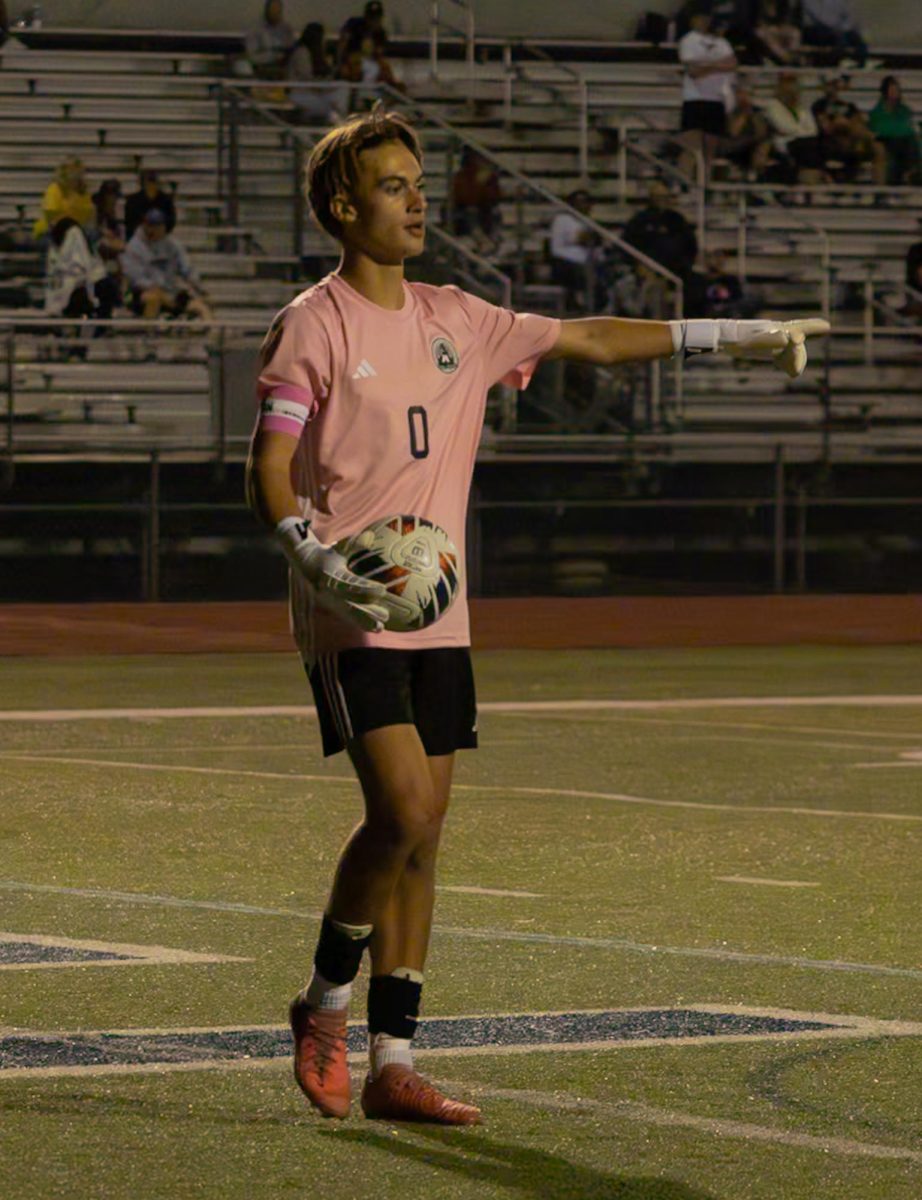 Senior Cooper Kambak attempts to get his teammate in the correct spot for a pass on Sept. 10. At the game, Kambak pointed to an open spot on the field so he could pass the ball. 
