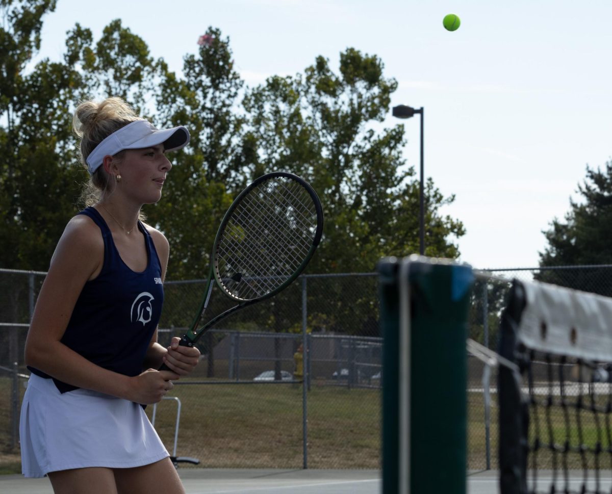 As the other team is about to serve, sophomore Isabel Black is ready to volley the ball right back. A volley is a strike of the ball made before it touches the ground.