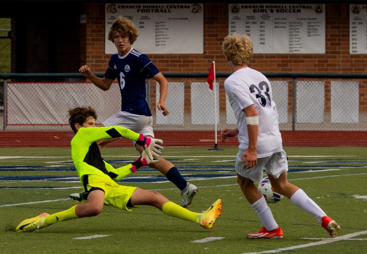 Goalkeeper, freshman Jack Morris lunges to intercept a shot by the player from Marquette. Morris’ teammate, junior Ethan Southard rushed behind and protected the goal. 