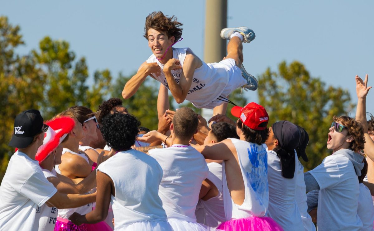 Senior Cole Joseph flies through the air during the 2024 Homecoming Pep Assembly. During the performance by the Senior Showmen, it is custom for one of the boys to be thrown. 