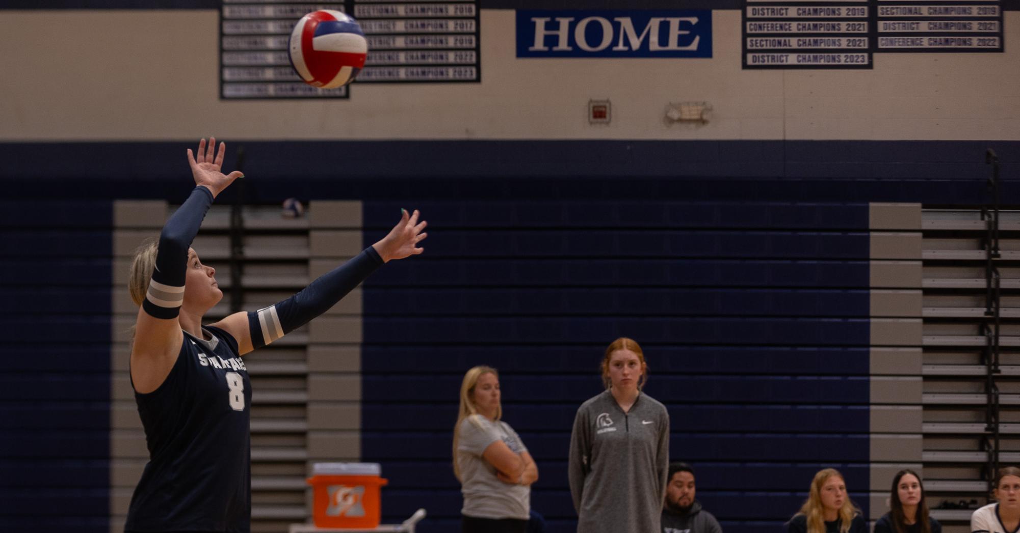 Senior Addie Henderson tosses the ball lightly in the air, her eyes always following the ball. She then served the ball to the opposing team and the Spartans were able to gain another point. 