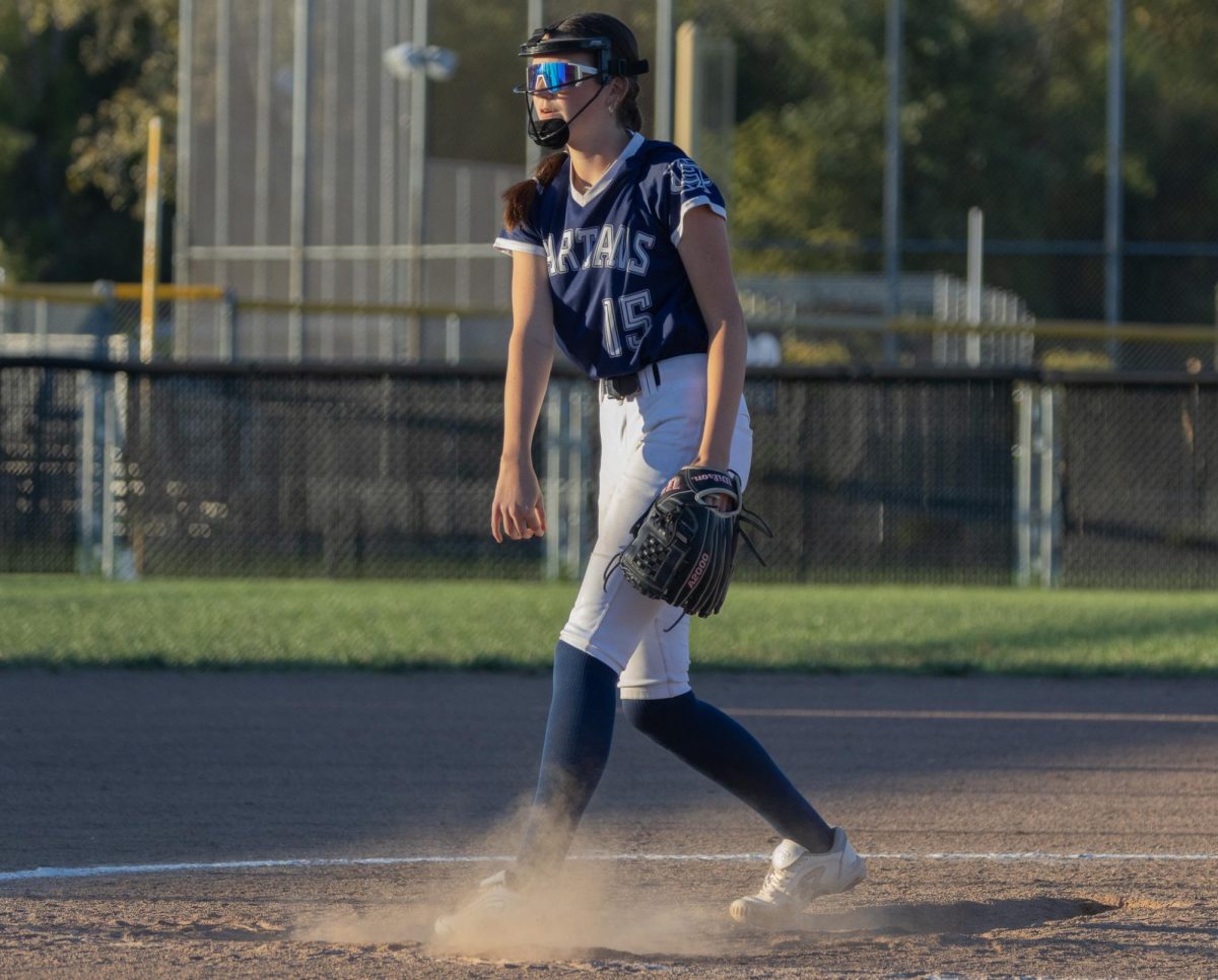 Freshman Amelia Meyer kicked up the dirt as she pitched to the batter.  She strided out long and followed through on her curveball.