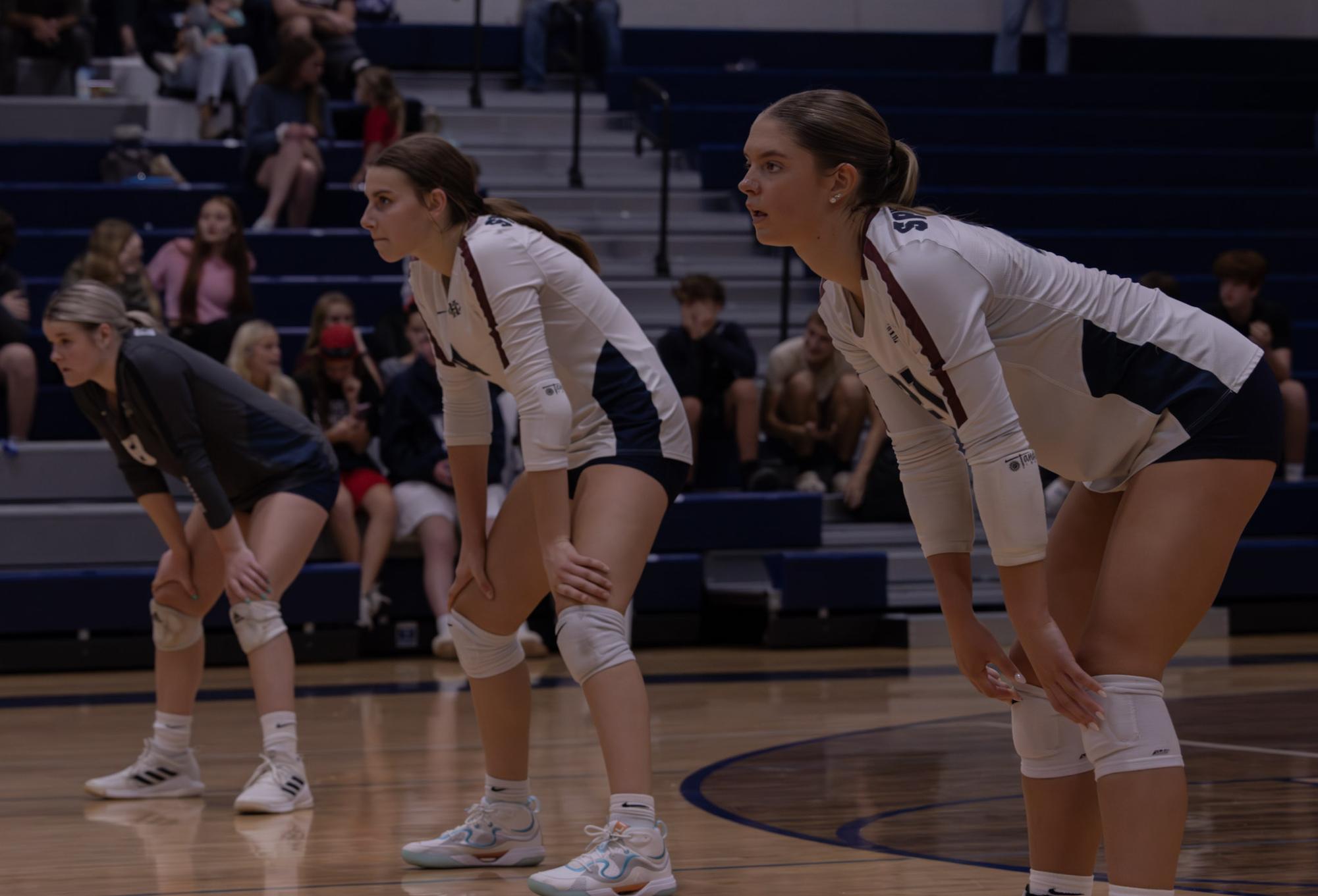 Seniors Logan Rubel and Addison Henderson as well as sophomore Ava Schuette and senior Addie Henderson all stand in the ready position on Sept. 24 at the game versus Francis Howell. The girls did this to ensure that they could hit the ball easier when it eventually came over the net. 