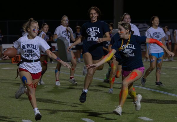 As junior Riley Shepard runs the ball down the field, senior Madison Scott runs to grab her flag. On Oct. 10, Scott ran as fast as she could to stop Shepard from getting closer to the end zone. 
