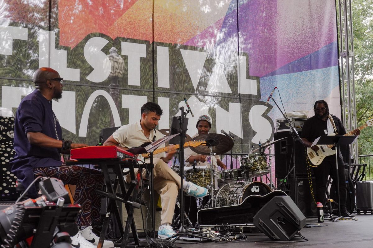 A band performs the instrumentals for an artist's performance. The Festival of Nations provides visitors with generous entertainment.