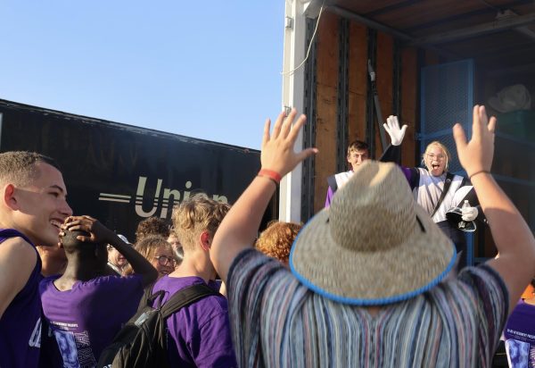  Sophomore Max Layman raises both arms above his head in celebration while senior Tia Harlow waves to him from the back of the trailer. Taken after their competition, this photo captured what Harlow described as a “really happy moment.”
