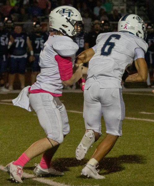 Starting quarterback junior Jason Campbell passes the ball to his teammate senior Ashton Payton. Payton then runs the ball up the field to help out Campbell.   
