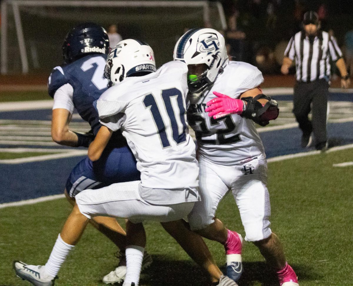 Senior Simeon Smith, a senior this year, delivers a tackle to his opponent with assistance from senior Eric Brock. The two easily take the Timberland player down and stop him in his tracks.
