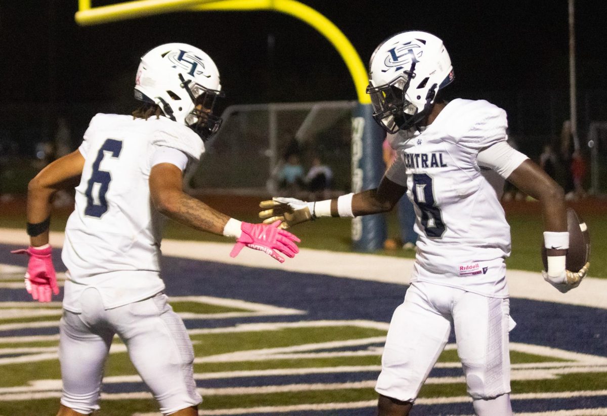 Juniors Ashton Payton and Don Thornton go to clutch hands after Thornton had scored a touchdown. With the ball still in Thornton’s grasp, the two boys celebrate their accomplishment. 