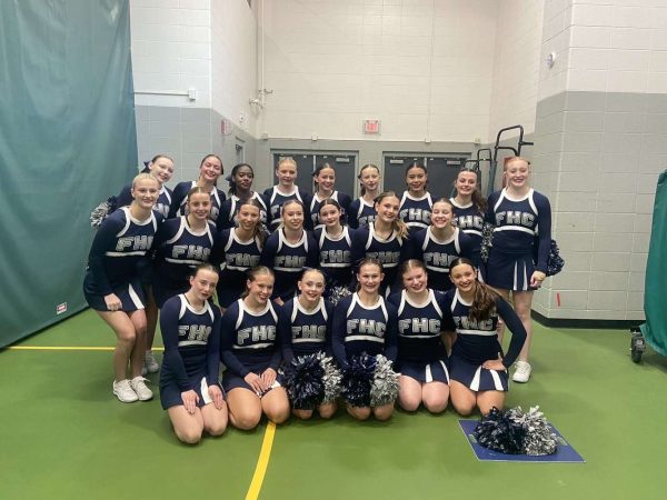 The varsity cheer team huddled together for a picture. This is before their performance at the Regional competition on Saturday Sept. 21.