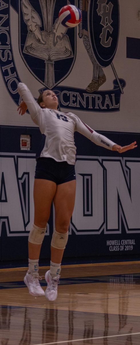 After winning the previous point senior Jordan Smith jumps in the air to increase her power while serving. In order to serve the ball, a team must win the previous point while also alternating their server with the next player in rotation.