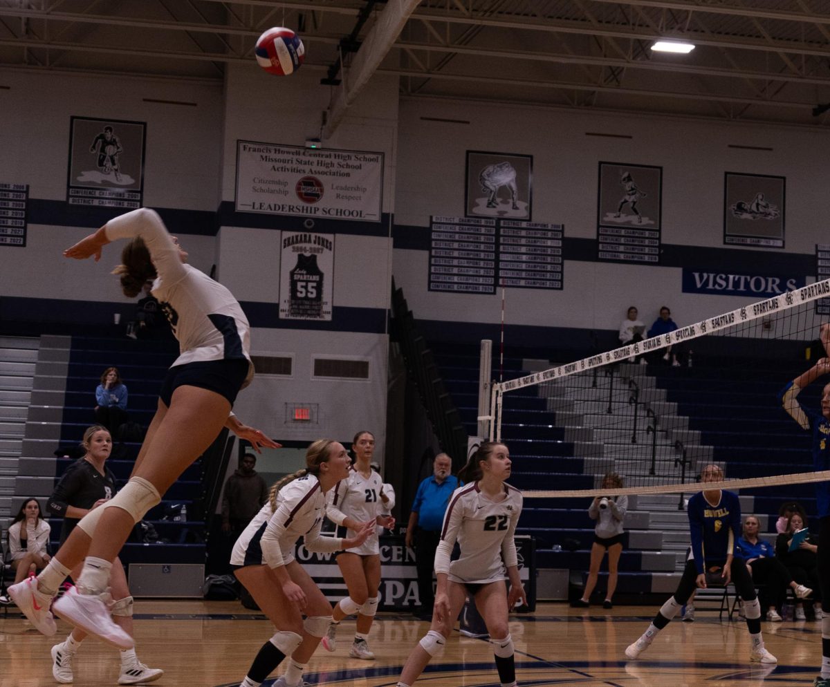 Senior Jordan Smith flies through the air as she prepares to spike the ball over the net. Smith was fed multiple spikes throughout the game which allowed her to win multiple points against Howell.