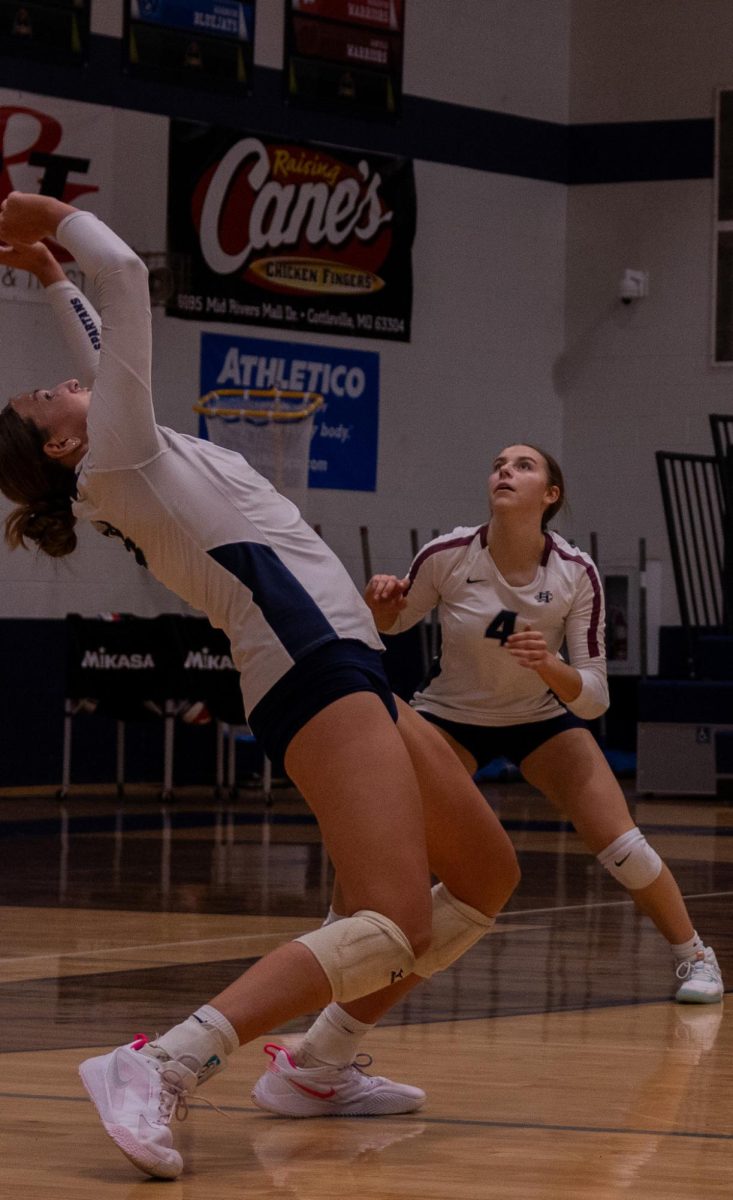 In order to stop the ball from hitting the ground, senior Jordan Smith contorts her body backward, allowing her to reach and set the ball. Although the libero is often responsible for reaching awkwardly placed balls, it is everyone's responsibility to prevent the ball from hitting the ground.