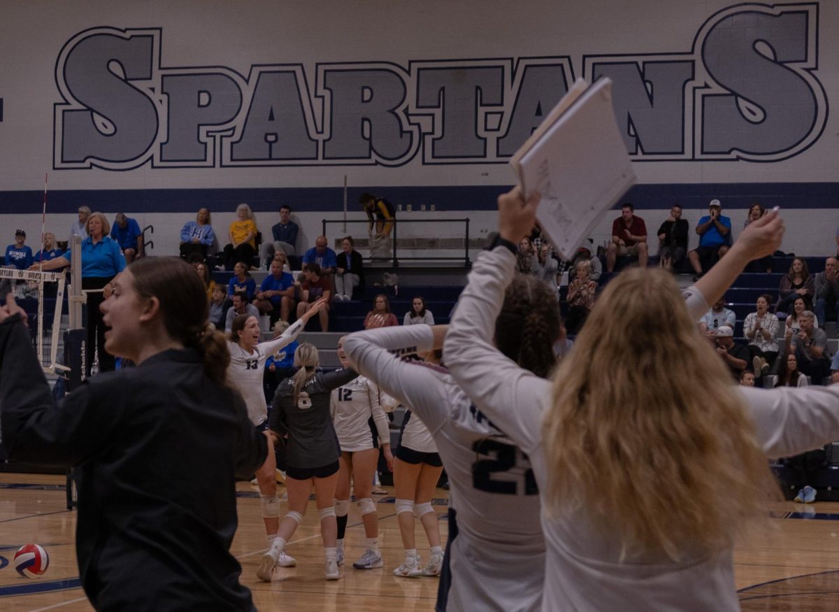 Behind a sea of their teammates, the Spartans on the court celebrate winning a close point. The energy of the team was felt on and off the bench as managers and teammates would build eachother up whether the point was won or lost.