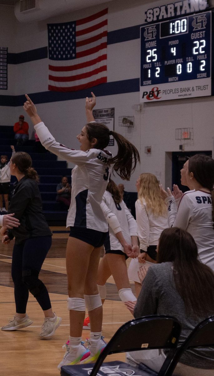 After winning the set, junior Mae McAdow jumps in the air as she celebrates getting to go into another set. After losing the first two sets Francis Howell Central went on to win the next two sets which brought them into a tiebreaker against Howell.