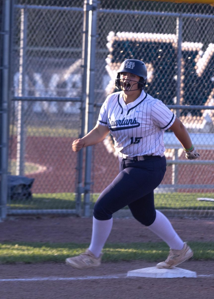 Amelia Raziq shouts in excitement as she sprints through the bases to home base as a result of Callison’s hit. Just before the game, Raziq had been honored for breaking a state record and tying another.