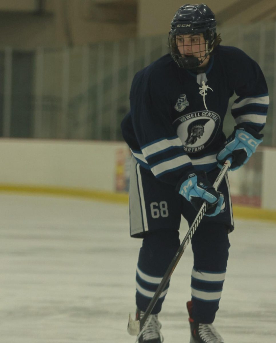 Freshman Roland Rausch gets the puck passed to him down the ice. He focuses so he can make a goal and score a point for the Spartans.
