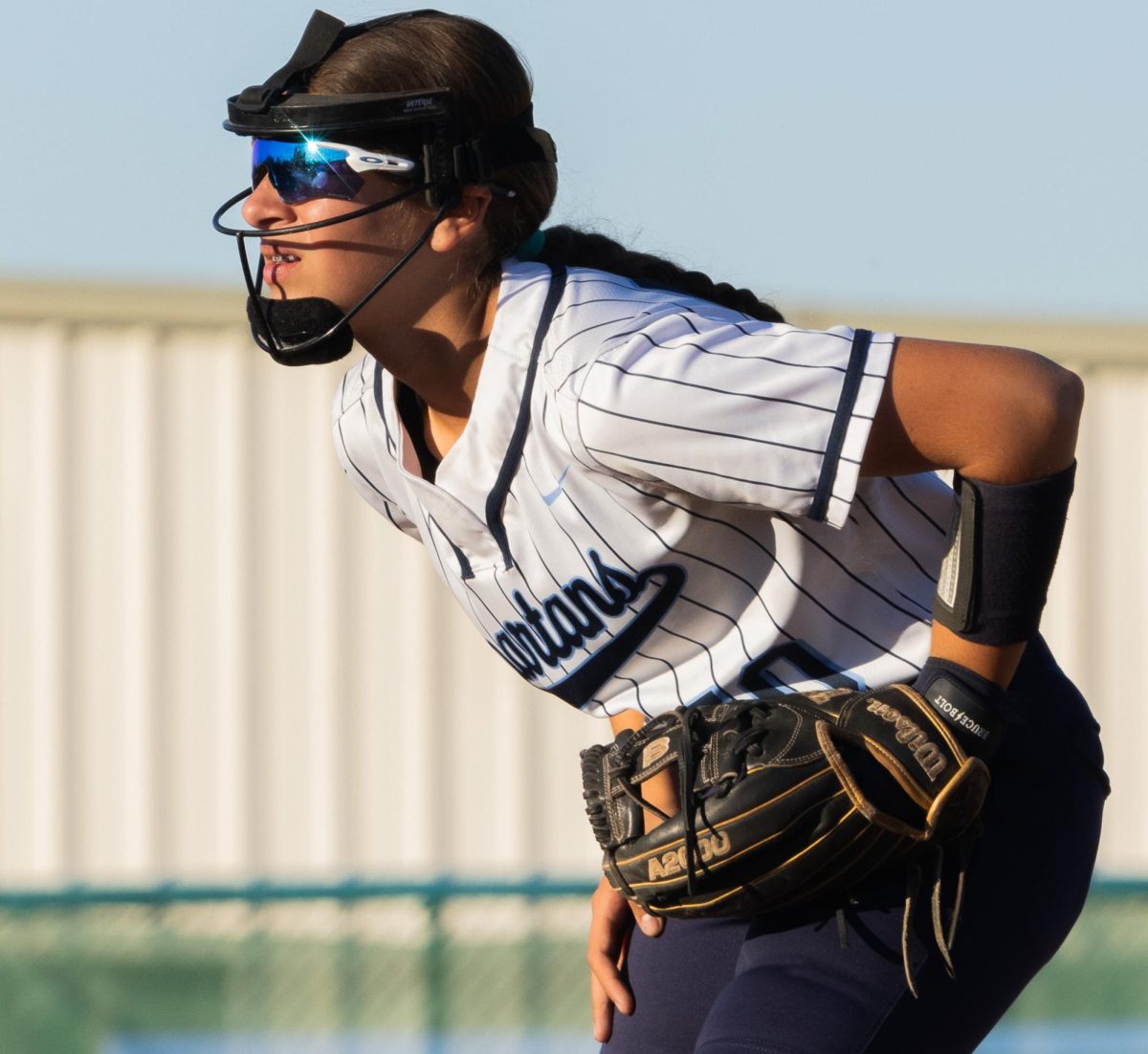 Freshman Rylee Breznay crouches down as the Francis Howell North player steps up to bat. While playing against Francis Howell North on Oct. 18, Breznay’s focus helped the Spartans secure the win. 