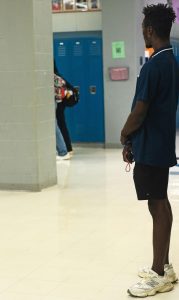 Hall monitor Caleb Saldana stands watching as students walk through the halls. "I make sure that kids are getting to class on time and make sure nobody's vaping in the bathrooms," Saldana said. Building principals have been working with teachers to keep down the number of students in the hallway during class time.